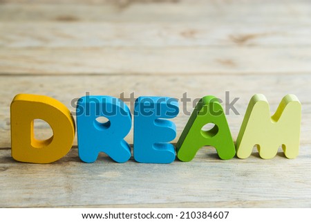 Colorful wooden word Dream on wooden floor