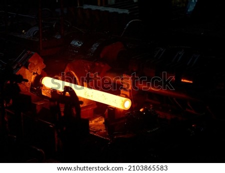 glowing steel tube during production in a modern rolling mill in the industry  Royalty-Free Stock Photo #2103865583