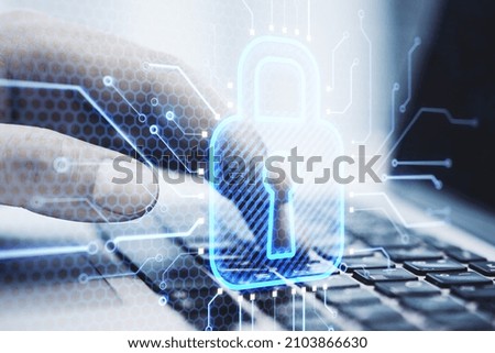 Close up of male hands using laptop keyboard with abstract glowing blue padlock circuit hologram on blurry background. Internet, workplace, information and safety concept. Double exposure