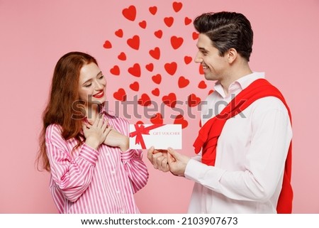 Young couple two friends woman man wear casual shirt hold giving gift certificate coupon voucher card for store isolated on plain pastel pink background. Valentine's Day birthday holiday party concept Royalty-Free Stock Photo #2103907673