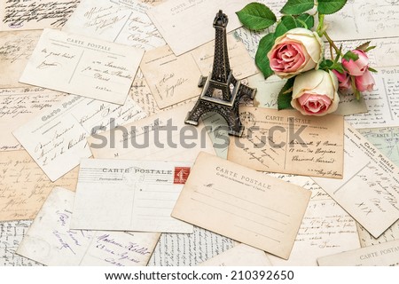 roses, antique french postcards carte postale and souvenir Eiffel Tower from Paris. nostalgic sentimental holidays background