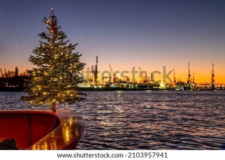 Hamburg, Germany. Christmas tree in the harbor at sundown.	