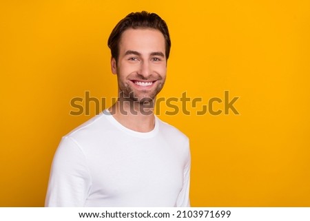 Photo of young cute brunet guy wear white shirt isolated on vivid yellow color background
