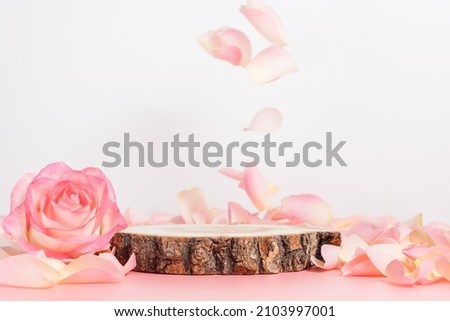 Empty wooden podium with rose and petals for display gifts, products or cosmetics Royalty-Free Stock Photo #2103997001
