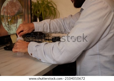 Teleworker washing his hands with gel before taking a rapid covid test