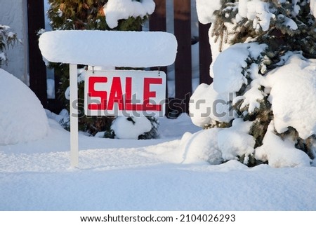 sale sign in snowy winter