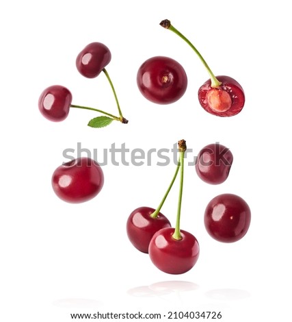 Fresh raw cheery falling in the air on white background. Food zero gravity conception. High resolution image Royalty-Free Stock Photo #2104034726