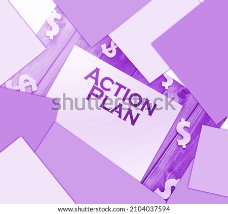 Action plan words, paper signs of dollar on wooden table. Business concept.