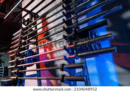 Huge barbell bar for a dumbbell in a gym. Sport and healthy life concept. Set of barbell bar on gym background. Sport equipment closeup