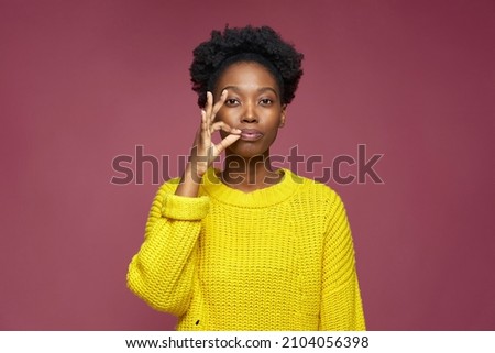 Stylish african american young girl showing be quiet gesture, promise to keep secret private information, ask silence Royalty-Free Stock Photo #2104056398