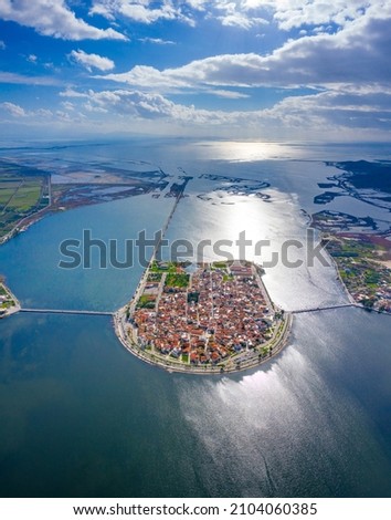 Aerial drone view of the famous island - fishing village of Aitoliko in Aetolia - Akarnania, Greece situated in the middle of Messolongi archipelago known as the Little Venice of Greece Royalty-Free Stock Photo #2104060385