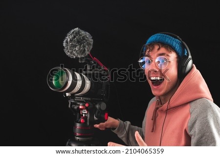 Filmmaker or cinematographer using professional camera gear to make documentaries and movies. Young cameraman, audiovisual, story telling and directing movies concepts.