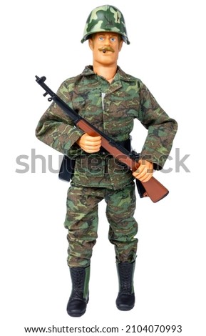 Plastic model of a soldier. Toy soldier. Isolate on a white background. Male doll in camouflage clothing.