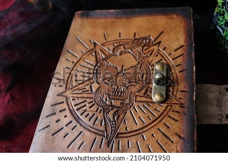 Mystical leather book of shadows with skull, snake and pentagram