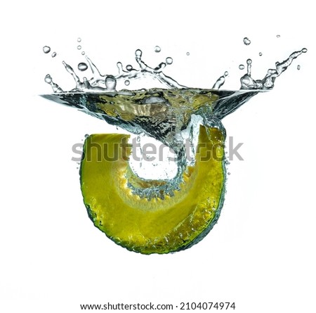 Pumpkin cut into the water against white background