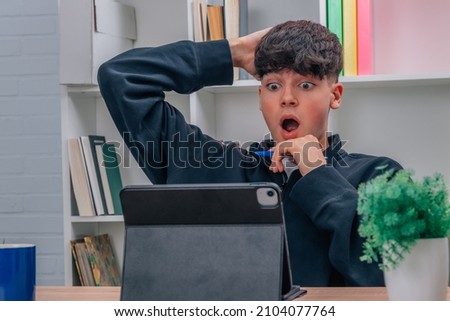 surprised young man looking at computer