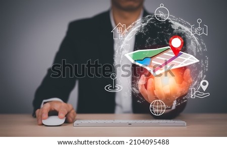 Businessman hand holding virtual world and model map with location point , GPS app, icon Travel maps and find places in the online system, all screen graphics are generated,Searching for travel goals. Royalty-Free Stock Photo #2104095488