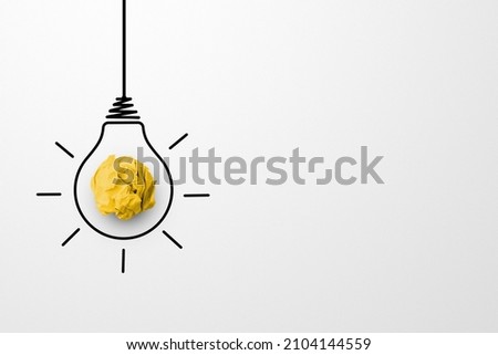 Creative thinking ideas and innovation concept. Paper scrap ball yellow colour with light bulb symbol on white background Royalty-Free Stock Photo #2104144559