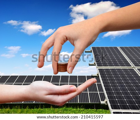 Female hands with money.In the background solar panel.