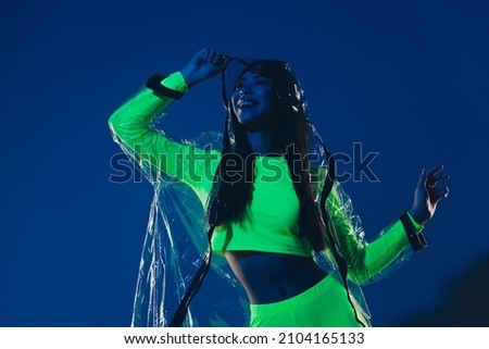 Photo of millennial lady wear rubber hood raincoat enjoy theme festival isolated vivid vibrant colorful background