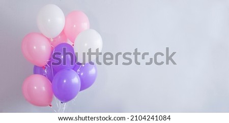 Bright balloons on a gray background