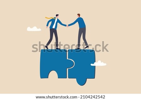 Collaborate, cooperate or partnership and agreement to help business success, together or teamwork support each other concept, success businessmen finish deal and handshake on jigsaw puzzle. Royalty-Free Stock Photo #2104242542