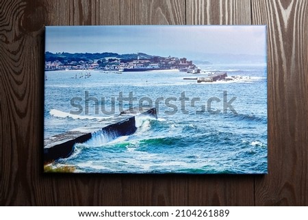 Canvas photo print hanging on brown wooden wall