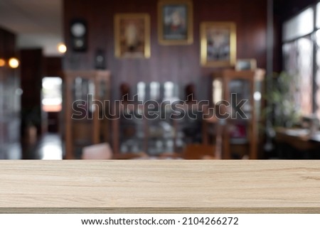 Empty wooden table space platform and blurred cafe or vintage club background for product display montage.