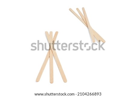 Disposable stick for coffee isolated on white background. Wooden stirrer sticks. Stir sticks for hot drinks. Coffee and tea spoon, zero waste. Popsicle elements for holding ice cream. Royalty-Free Stock Photo #2104266893