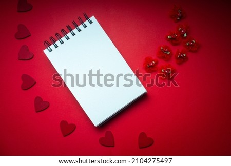 romantic valentine mock up with blank note pad on red background with hearts for your message ,copy space