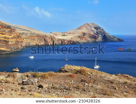 Madeira. Picturesque white boat in a rocky bay on the east of the island