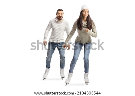 Full length portrait of a young casual man and woman ice skating towards camera isolated on white background