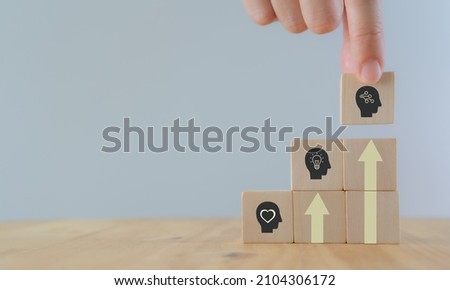 Skills development concept. New skills for technology evolution. Soft, thinking,digital skill. Hand holds wooden cubes with digital skill icon on white background, copy space. Reskilling, upskilling. Royalty-Free Stock Photo #2104306172
