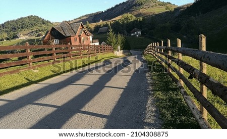 rural landscape. the village in the photo. road in a mountain village. shadows.