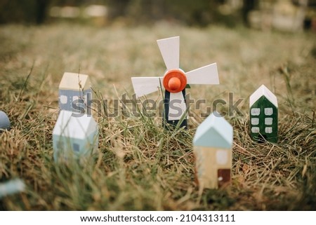 Conceptual photo of real estate. Small wooden houses on the grass