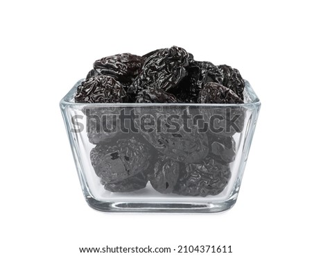 Bowl with sweet dried prunes isolated on white