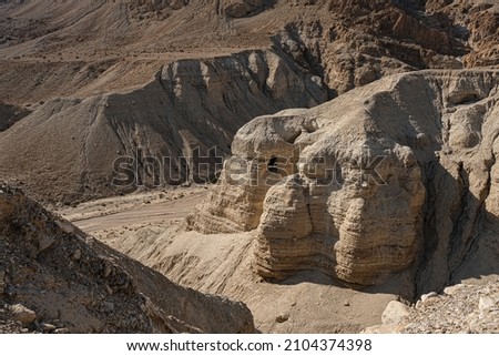 View of the Qumran caves at Wadi Quimran in the Judean desert, the caves where the Dead Sea Scrolls were discovered, Qumran National Park, Israel.  Royalty-Free Stock Photo #2104374398