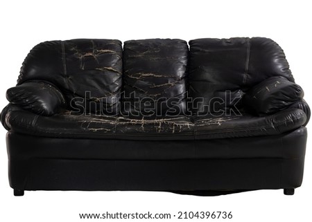 Damaged black leather sofa isolated on white background included clipping path. Royalty-Free Stock Photo #2104396736
