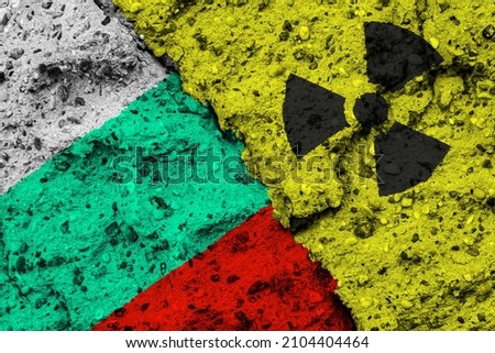 Concept of the Nuclear Energy Policy of Bulgaria with a flag and a radiation hazard sign painted on a rough wall