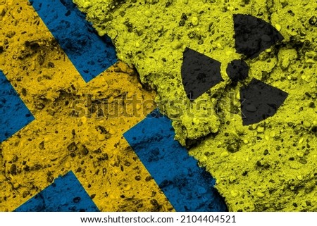 Concept of the Nuclear Energy Policy of Sweden with a flag and a radiation hazard sign painted on a rough wall