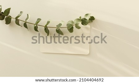 Empty Blank texture canvas paper card and eucalyptus leaf branch with copy for your text message. Light and shadows minimalism style template background. Flat lay, top view.