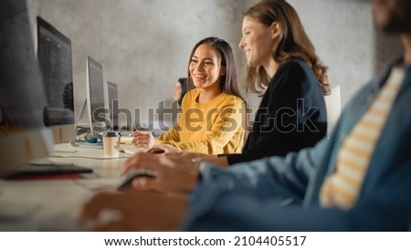 Smart Young Students Studying in University with Diverse Multiethnic Classmates. Scholars Collaborate in College Room with Computers. Applying Knowledge to Acquire Academic Skills in Class. Royalty-Free Stock Photo #2104405517
