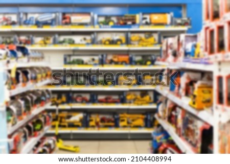 Blurred image of shelves with toy cars in a toy shop.  Royalty-Free Stock Photo #2104408994