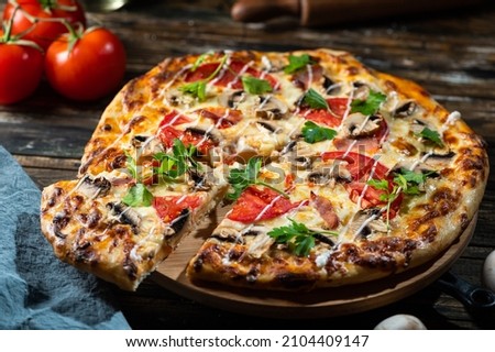 tasty juicy pizza on wooden background. lots of meat and cheese. Mushroom pizza. Pepperoni pizza. Mozzarella and tomato. Italian dish. Italian food. Comfort food. Local food.