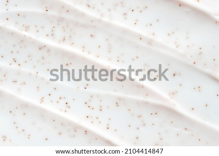 Face scrub texture. Cream skincare cosmetic. Organic stroke. Feet oily cleanser smudge. Particles in gel. White background. Top view. Fluid treatment Royalty-Free Stock Photo #2104414847