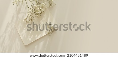 Empty Blank texture canvas paper card and gypsophila flower with copy for your text message. Light and shadows minimalism  template horizontal long background. Flat lay, top view. Beige color tone.