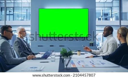 Office Conference Room Meeting using Green Screen Chroma Key TV: Multi-Ethnic Group of Top Managers, Executives Talk. Businesspeople Work on an e-Commerce Strategy.
