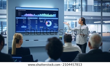 Modern Product Presentation Event: Black Businesswoman Talks about e-Commerce Product Big Data Statistics, Charts, Revenue Growth Infographics. Live Press Conference for Digital Businesspeople Royalty-Free Stock Photo #2104457813
