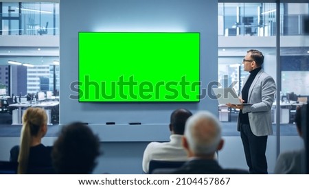 Modern Product Presentation Event: Caucasian Businessman Speaks, Uses Green Chroma Key Screen Wall TV. Press Conference for Group of Diverse Investors, Digital Entrepreneurs