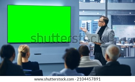 Modern Product Presentation Event: Caucasian Businessman Speaks, Uses Green Chroma Key Screen Wall TV. Press Conference for Group of Diverse Investors, Digital Entrepreneurs, Businesspeople